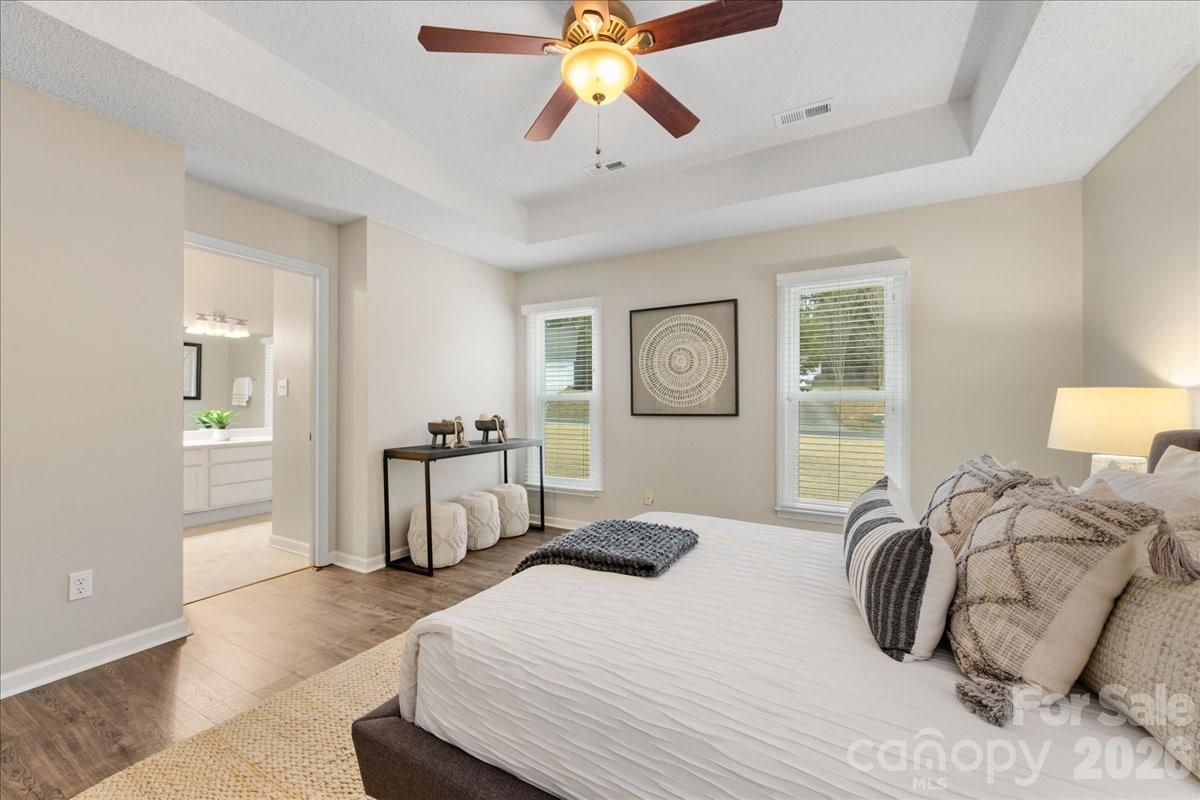 7800 Trotter Road Charlotte, NC 28216 - Photo 24 of 46 a bedroom with a bed and a chandelier