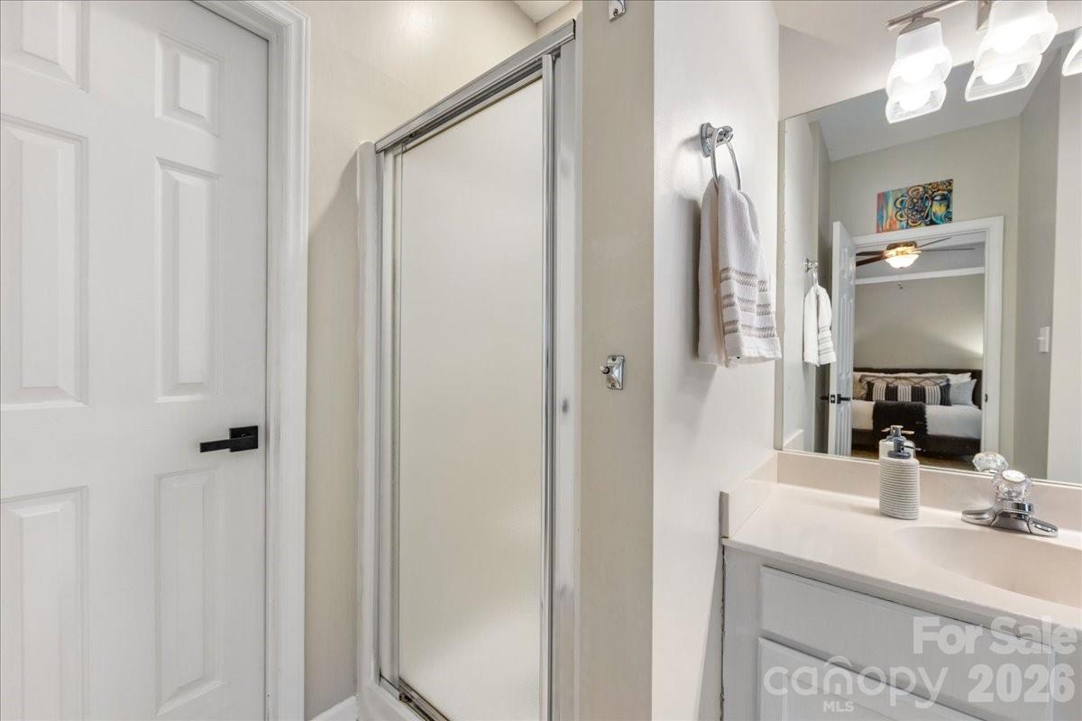 7800 Trotter Road Charlotte, NC 28216 - Photo 26 of 46 a bathroom with a double vanity sink and mirror