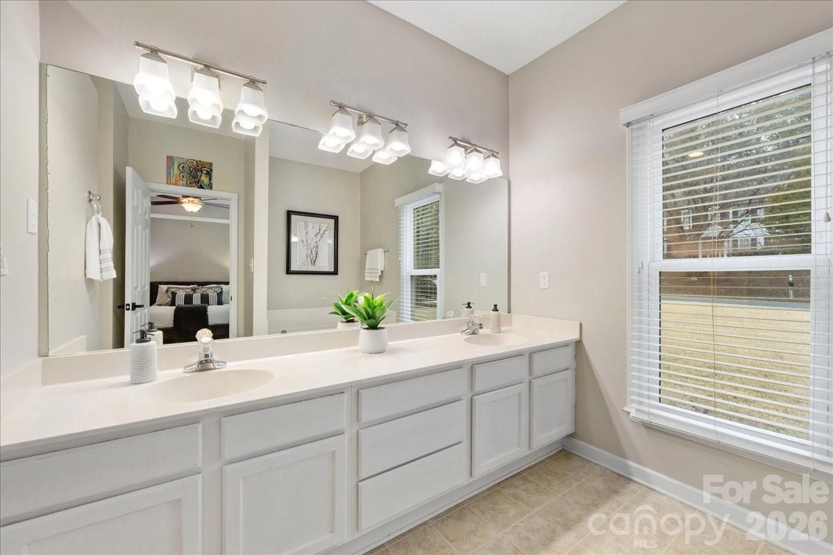 7800 Trotter Road Charlotte, NC 28216 - Photo 27 of 46 a bathroom with a double vanity sink and a mirror