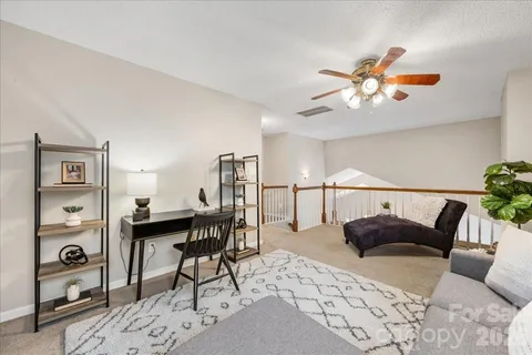 a view of a livingroom with furniture and a potted plant