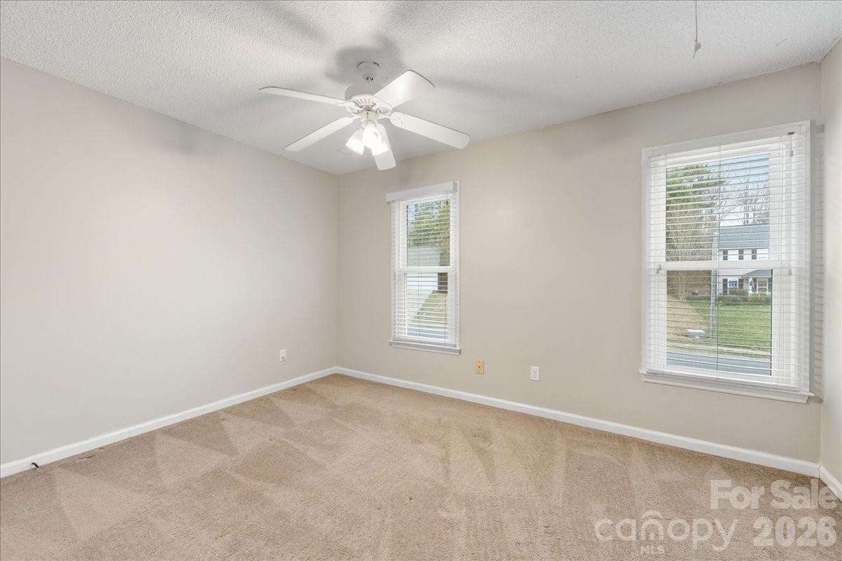 7800 Trotter Road Charlotte, NC 28216 - Photo 34 of 46 an empty room with windows and fan