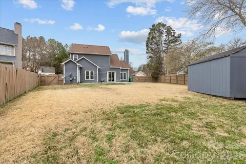 a view of a house with a yard and covered with snow