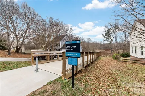 a view of a park with iron fence