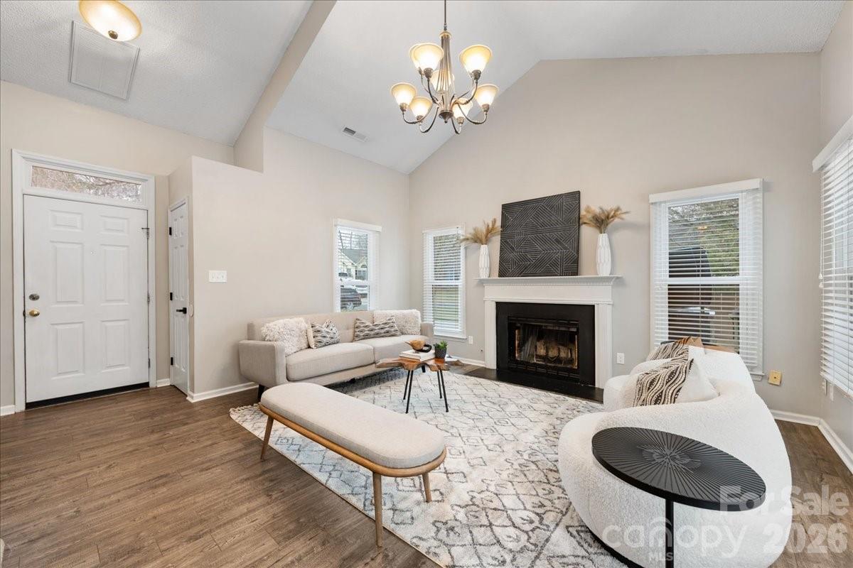 7800 Trotter Road Charlotte, NC 28216 - Photo 7 of 46 a living room with furniture a fireplace and a flat screen tv