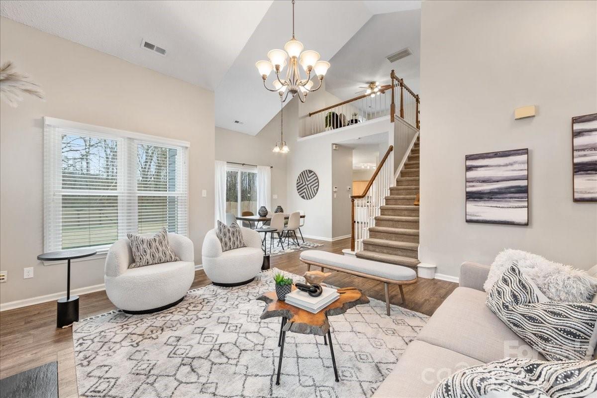 7800 Trotter Road Charlotte, NC 28216 - Photo 9 of 46 a living room with furniture and a chandelier