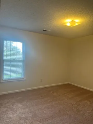 an empty room with a empty space and a window