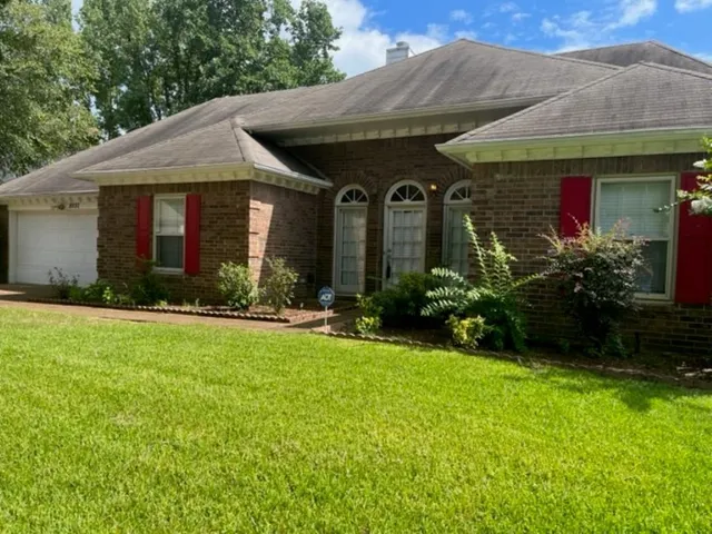 a front view of house with yard and outdoor seating