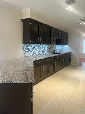 a kitchen with stainless steel appliances kitchen island granite countertop a sink and cabinets
