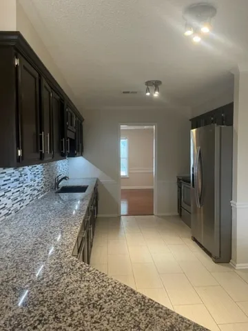 a view of entryway with kitchen