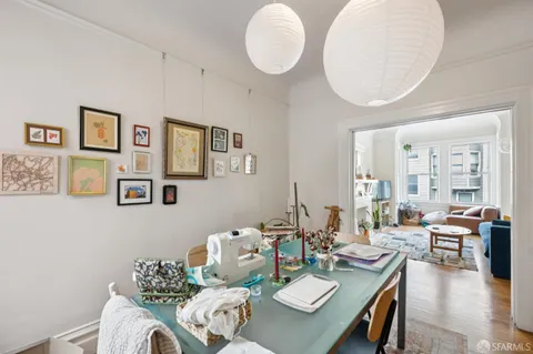 a living room with furniture potted plant and a large mirror
