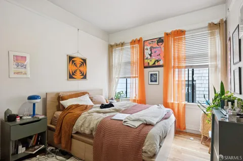 a bedroom with a bed and a painting on the wall