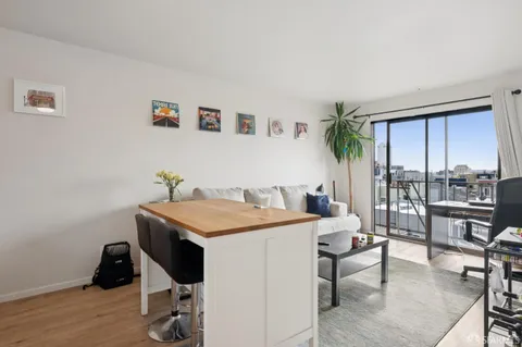 a view of a workspace with furniture and a potted plant