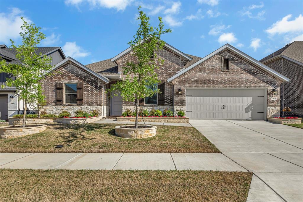 785 Emerald Heights Lavon, TX 75166 - Photo 1 of 1 View of front facade with brick siding, a front yard, driveway, and a garage
