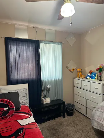 a living room with furniture gym equipment and a mirror