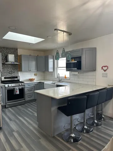 a bed sitting in a bedroom next to a dresser with wooden floor