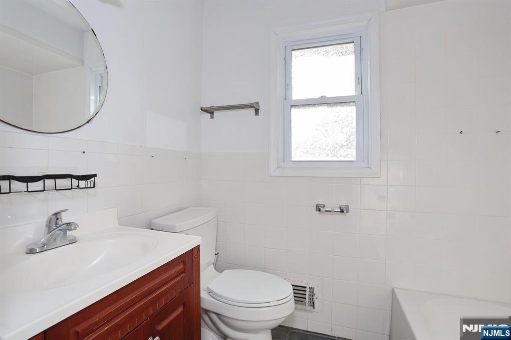 31 Madison Avenue Demarest, NJ 07627 - Photo 11 of 20 a bathroom with a sink a toilet and a mirror