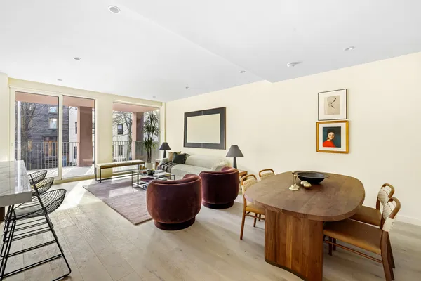 a living room with furniture a flat screen tv and a window