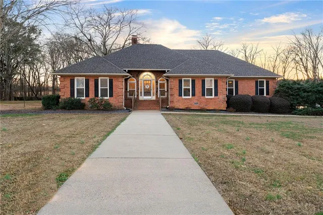 a front view of a house with a garden