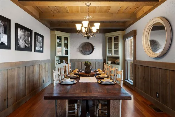a kitchen with kitchen island granite countertop wooden floors stainless steel appliances and a counter space
