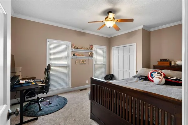 a view of a bedroom with furniture and balcony