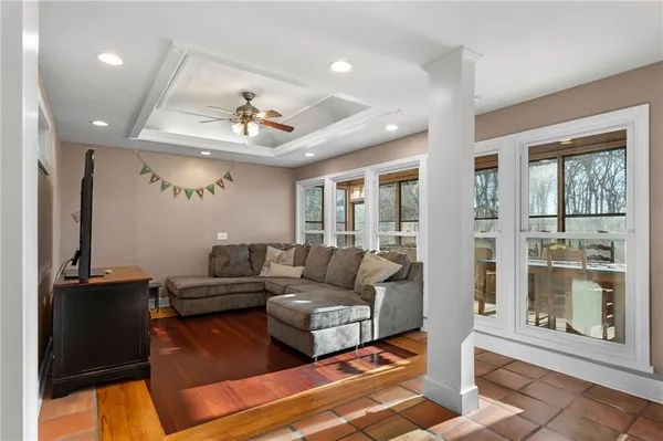 a lobby with a couches and kitchen view with wooden floor