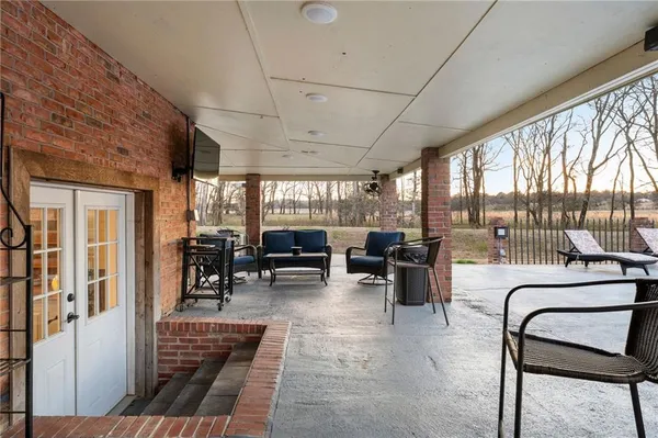a view of a house with swimming pool and sitting area