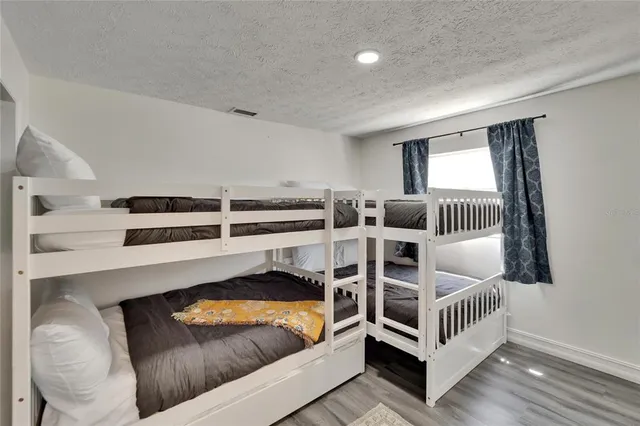 a bathroom with a sink a toilet a mirror and shower