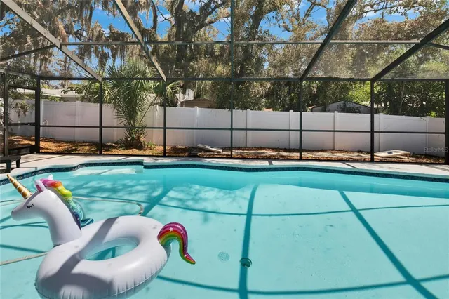 a view of backyard with swimming pool and outdoor seating