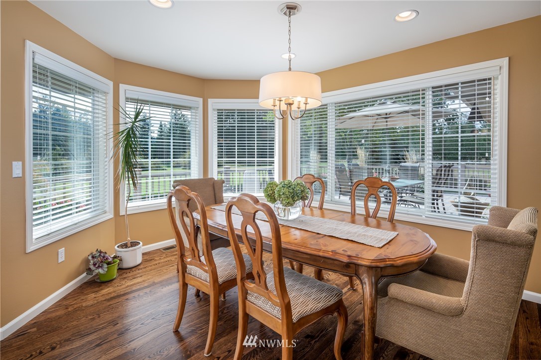 5044 Mission Road Bellingham, WA 98226 - Photo 11 of 40 a dining room with furniture a chandelier and wooden floor