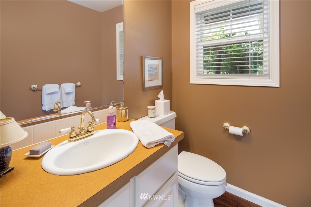 5044 Mission Road Bellingham, WA 98226 - Photo 17 of 40 a bathroom with a sink a toilet and a mirror