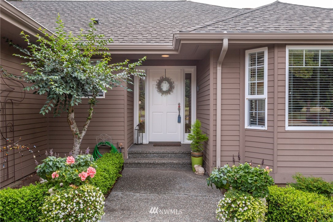 5044 Mission Road Bellingham, WA 98226 - Photo 3 of 40 a front view of a house with a yard