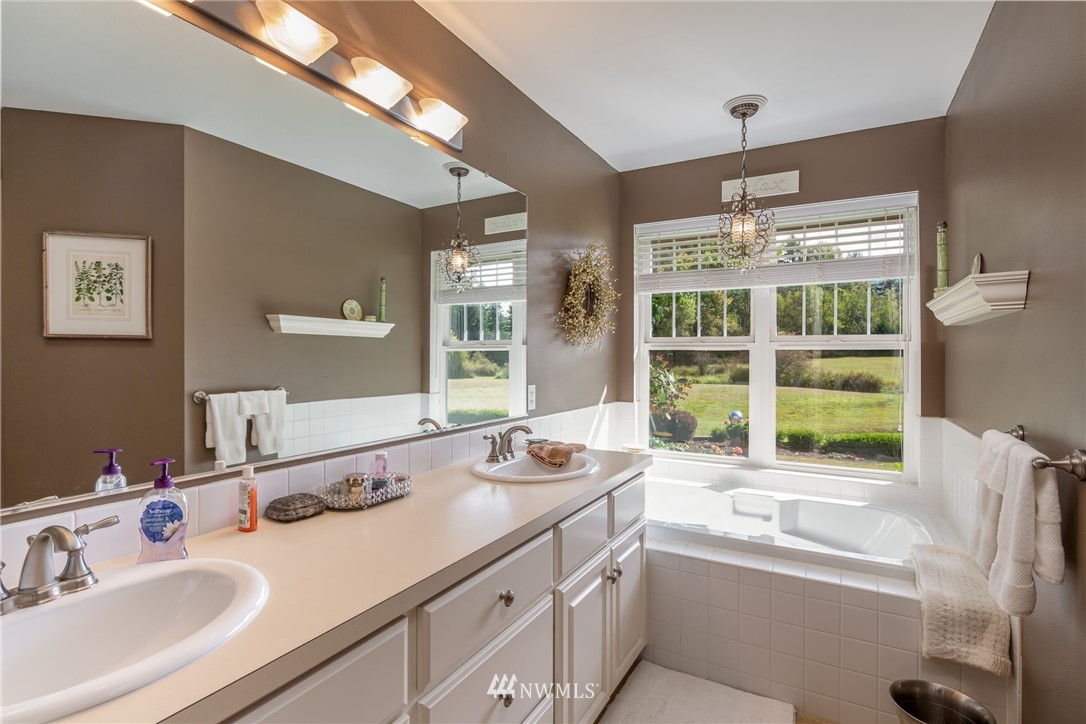5044 Mission Road Bellingham, WA 98226 - Photo 21 of 40 a bathroom with a sink double vanity and a tub