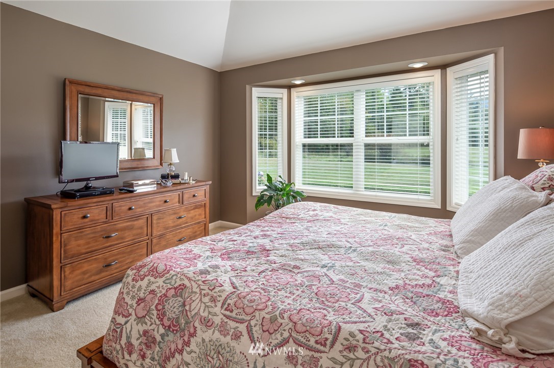 5044 Mission Road Bellingham, WA 98226 - Photo 27 of 40 a bed sitting in a bedroom next to a window
