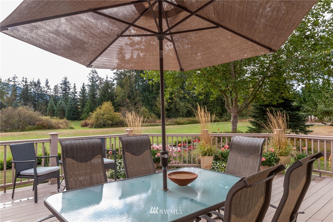 5044 Mission Road Bellingham, WA 98226 - Photo 31 of 40 a view of a patio with couches chairs under an umbrella