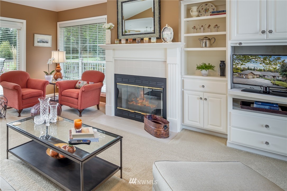 5044 Mission Road Bellingham, WA 98226 - Photo 9 of 40 a living room with furniture a flat screen tv and a fireplace