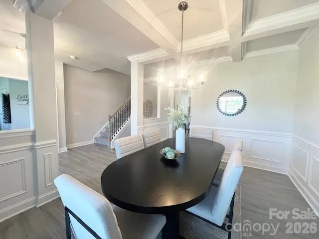 a view of a hallway to an entryway with wooden floor