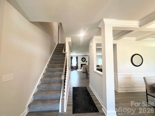 a view of entryway and hall with wooden floor