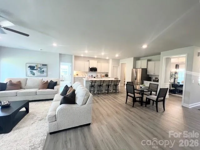 a bathroom with a double vanity sink toilet mirror and bathtub