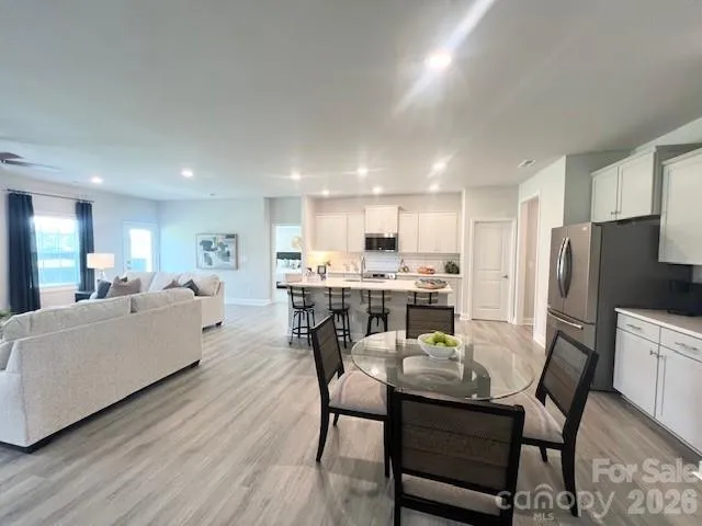 a view of a dining room with furniture and wooden floor