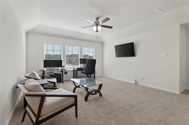 a bedroom with a bed and painting on the wall