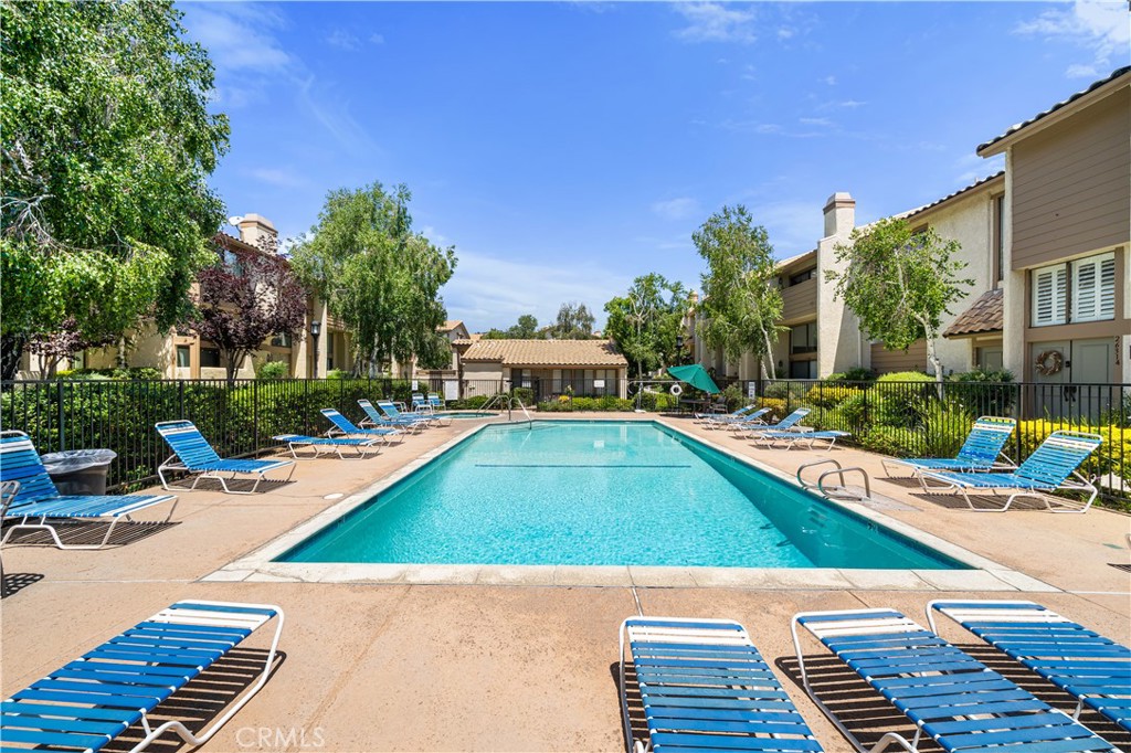 5510 Las Virgenes Road Calabasas, CA 91302 - Photo 14 of 16 a view of a swimming pool with a lounge chair and couches in the patio
