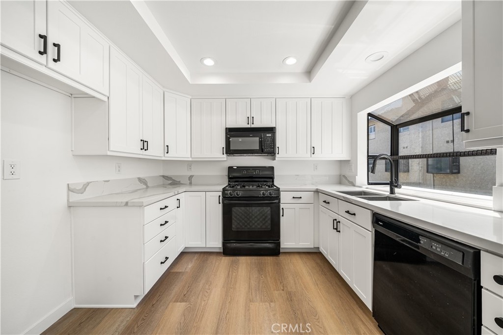 5510 Las Virgenes Road Calabasas, CA 91302 - Photo 4 of 16 a kitchen with granite countertop white cabinets and stainless steel appliances