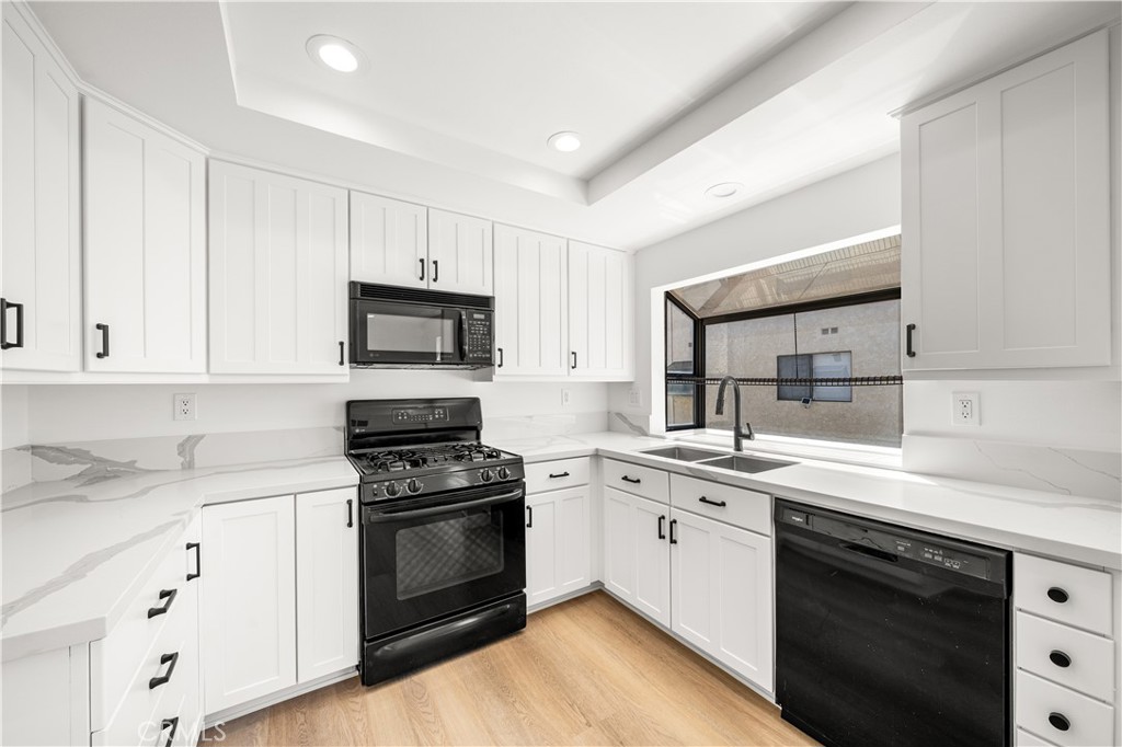 5510 Las Virgenes Road Calabasas, CA 91302 - Photo 5 of 16 a kitchen with cabinets stainless steel appliances and sink