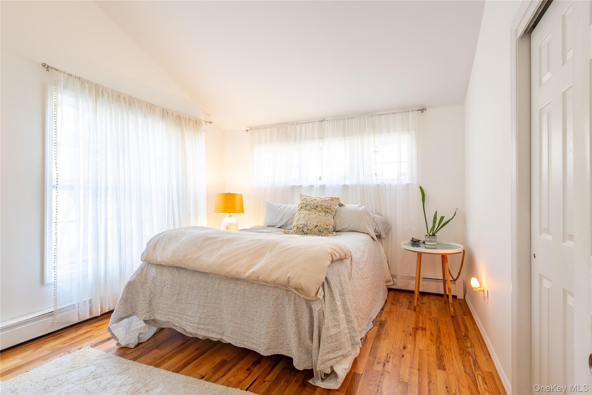 50 Prince Road Rocky Point, NY 11778 - Photo 14 of 30 a spacious bedroom with a bed and wooden floor