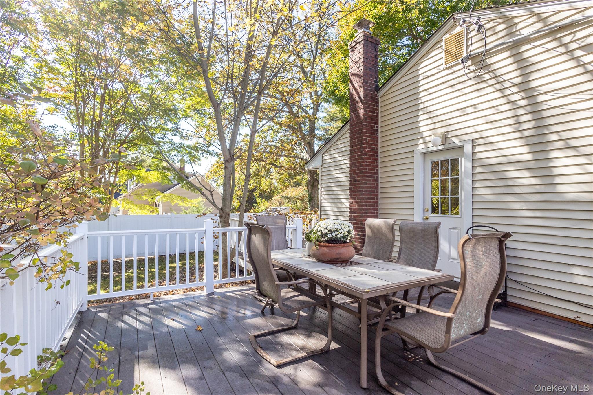 50 Prince Road Rocky Point, NY 11778 - Photo 20 of 30 a view of a patio with table and chairs and wooden fence