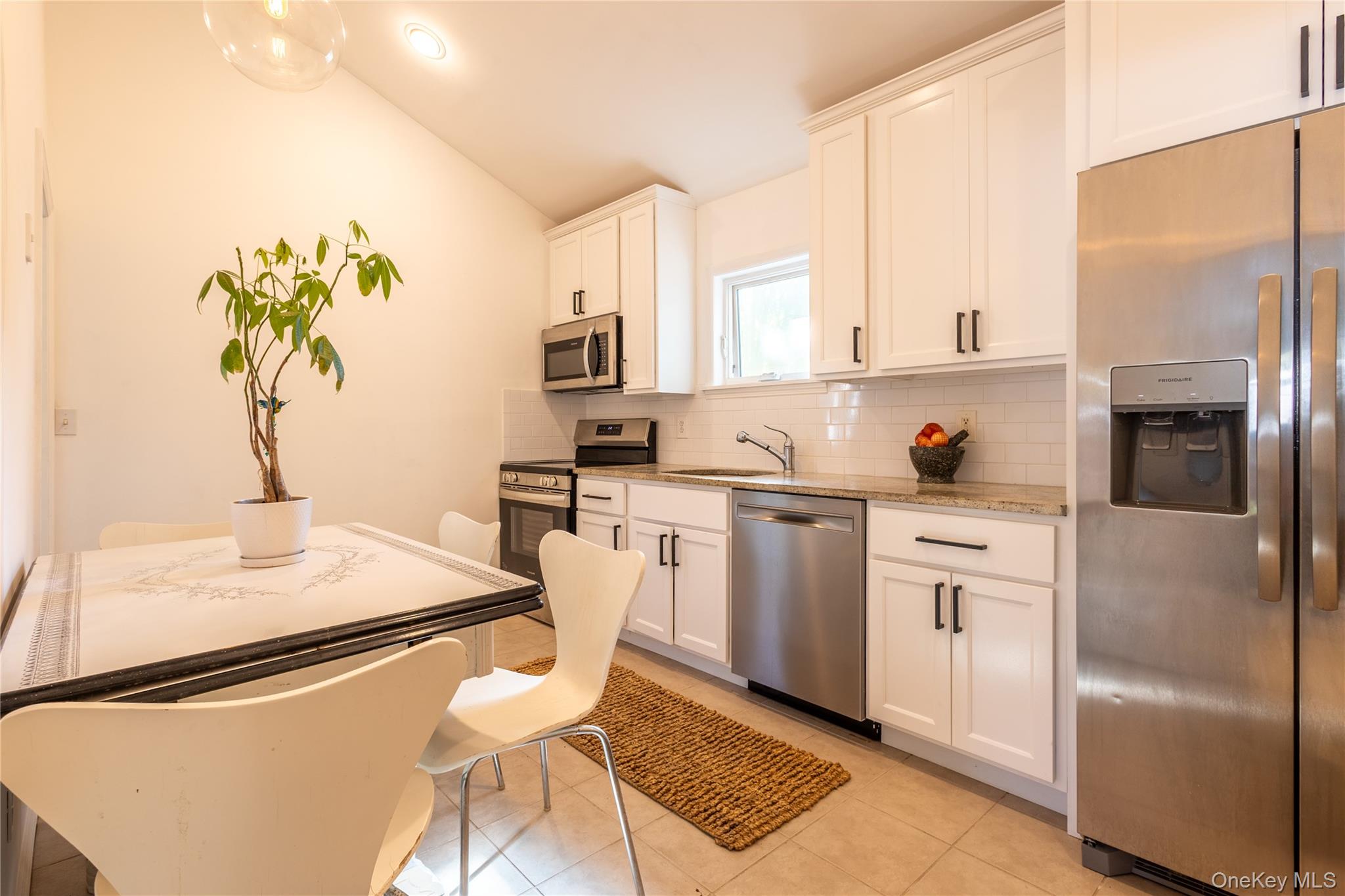 50 Prince Road Rocky Point, NY 11778 - Photo 8 of 30 a kitchen with white cabinets and white appliances