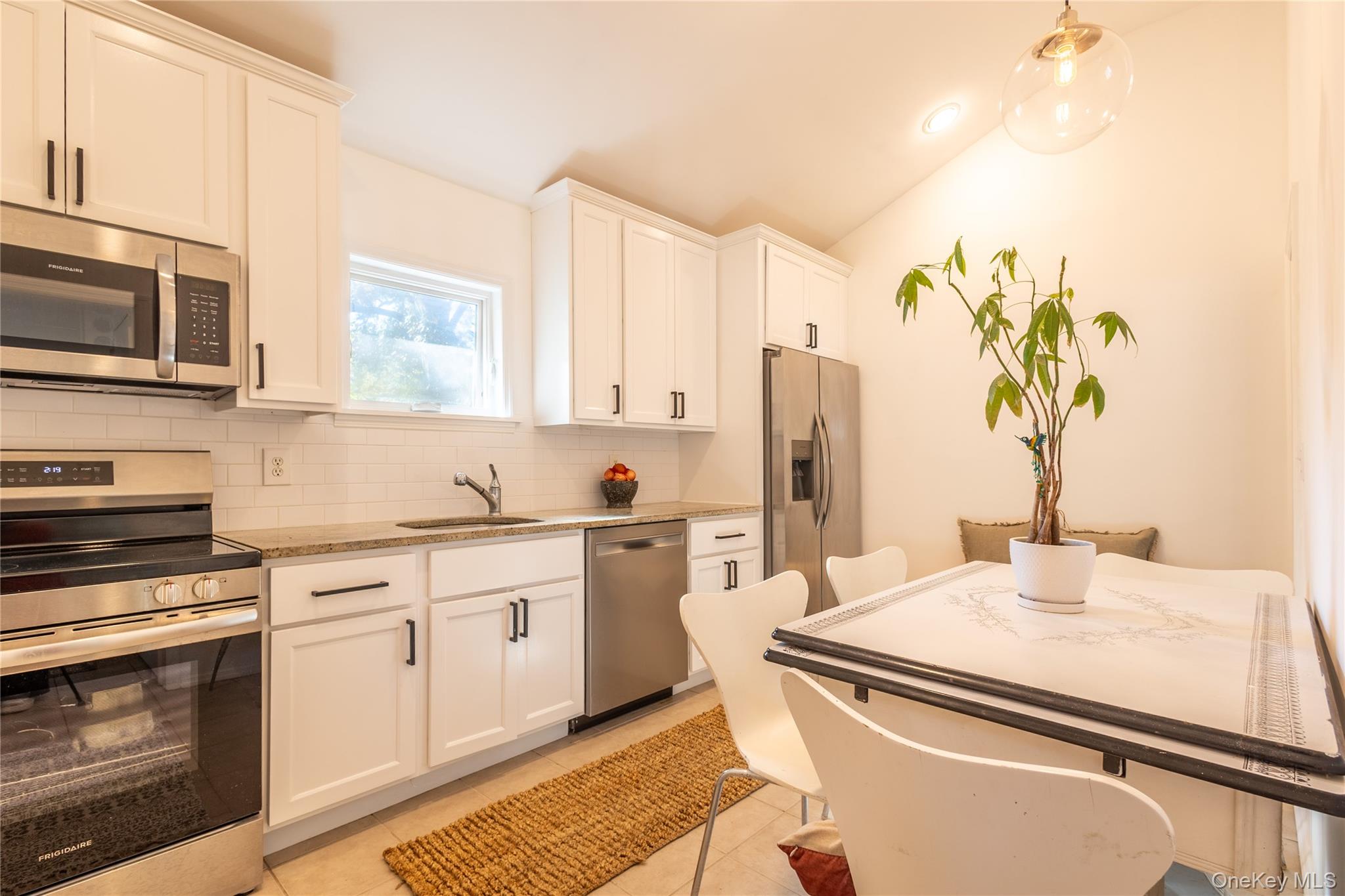 50 Prince Road Rocky Point, NY 11778 - Photo 9 of 30 a kitchen with stainless steel appliances a sink a stove and a refrigerator