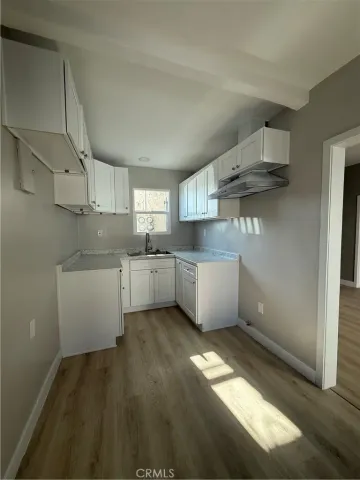 a kitchen with stainless steel appliances a sink stove and cabinets