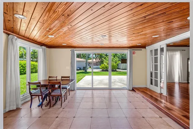 a view of a porch with chairs and backyard