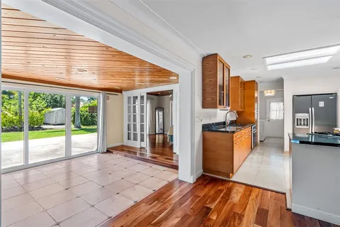 a view of a living room and kitchen with a large window